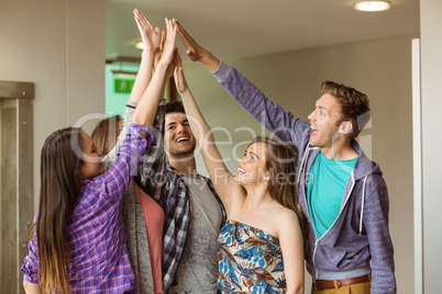 Happy friends students high five for their teamwork