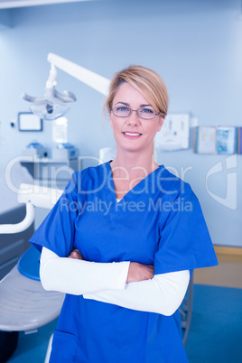 Dentist smiling at camera with arms crossed