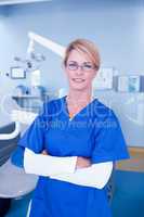 Dentist smiling at camera with arms crossed