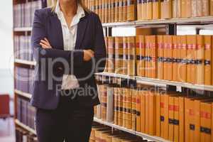 Mature female librarian posing with crossed arms