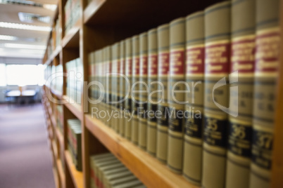 Volumes of books on bookshelf in library