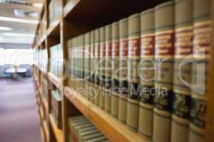 Volumes of books on bookshelf in library