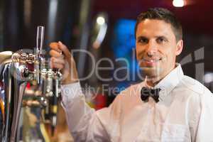 Handsome barman smiling at camera