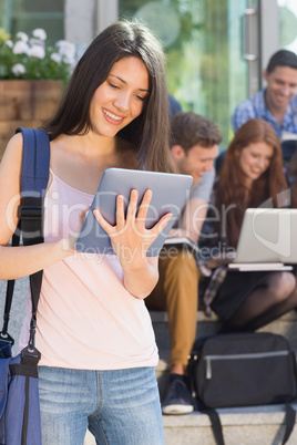 Pretty student using her tablet pc on campus