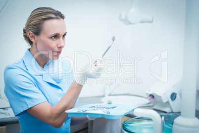 Female dentist holding dental tool