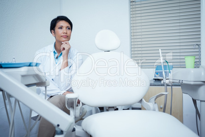 Thoughtful young female dentist