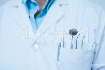 Mid section of dental tools in dentists pocket