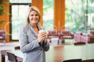 Blonde businesswoman smiling at camera