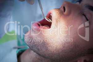 Close up of man having his teeth examined