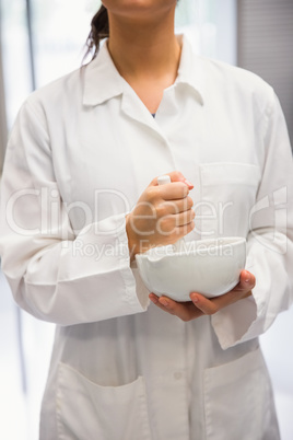 Junior pharmacist mixing a medicine