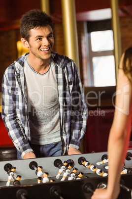 A brown hair playing table football