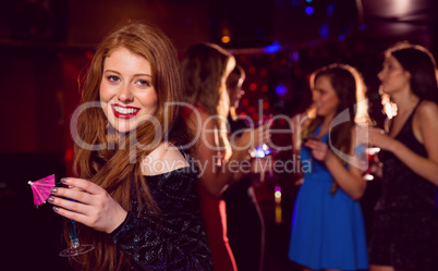 Pretty redhead drinking a cocktail