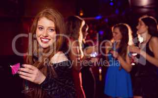 Pretty redhead drinking a cocktail