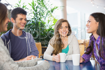 Young students having coffee together