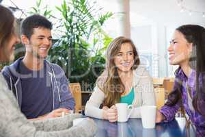 Young students having coffee together