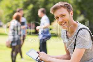 Handsome student studying outside on campus