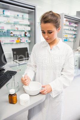 Junior pharmacist mixing a medicine