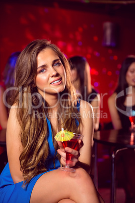 Pretty blonde drinking a cocktail