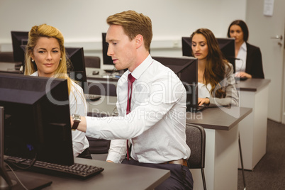 Boss talking and looking at laptop
