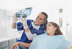 Pediatric dentist explaining to young patient the x-ray