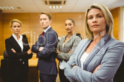 Serious lawyer standing with arms crossed