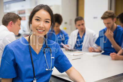 Medical student smiling at the camera during class