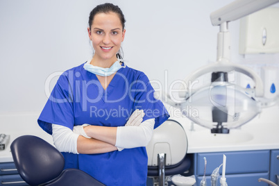 Portrait of a cheerful dentist with arms crossed