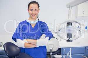 Portrait of a cheerful dentist with arms crossed