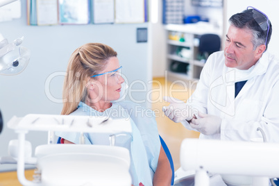 Dentist talking with his patient