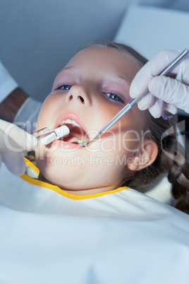 Close up of girl having her teeth examined