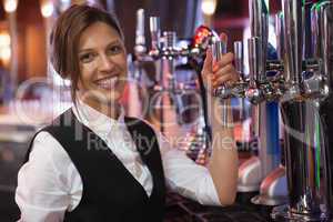Happy barmaid smiling at camera