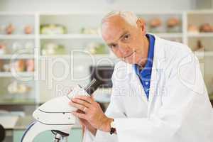 Senior scientist working with microscope