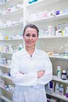 Portrait of a smiling student in lab coat with arms crossed