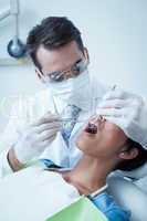 Male dentist examining womans teeth