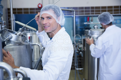 Portrait of a smiling scientist working with brewer