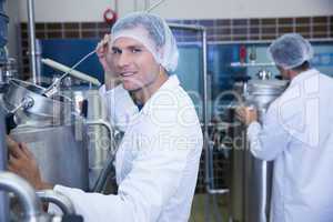 Portrait of a smiling scientist working with brewer