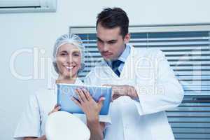 Dentists using digital tablet