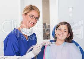 Portrait of a smiling pediatric dentist and young patient
