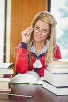 Smiling mature student reading book