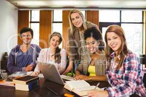 Student smiling at the camera with their teacher