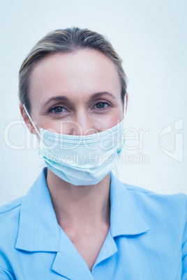 Female dentist wearing surgical mask