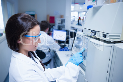 Young chemist using the machine