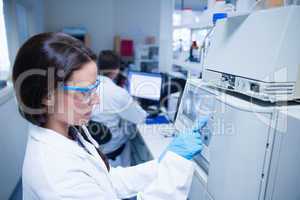 Young chemist using the machine