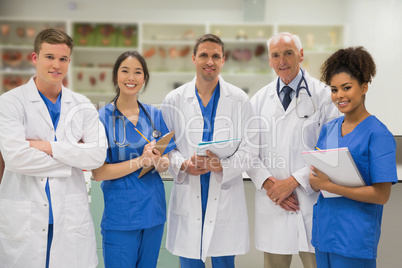 Medical professor smiling at camera with students