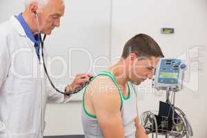Doctor listening to patient with stethoscope
