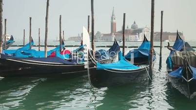 Venetian gondolas tied near the pier on San Marco square, Venice, Italy