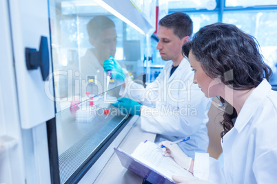 Science students using pipette in the lab