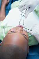 Boy having his teeth examined by dentist