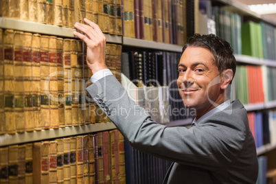 Lawyer picking book in the law library