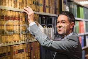 Lawyer picking book in the law library